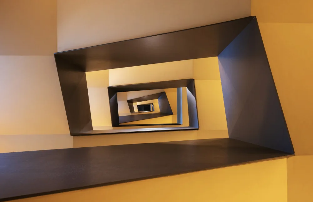 Oostrum, van Marc: Several geometric forms in shades from yellow to brown of a staircase in Frankfurt