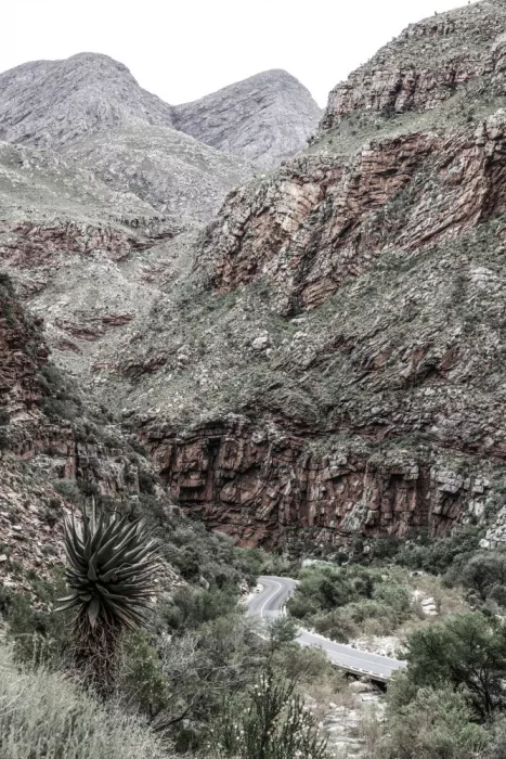 Clint, by Shot: Mountain Road Through A Rugged Canyon Landscape