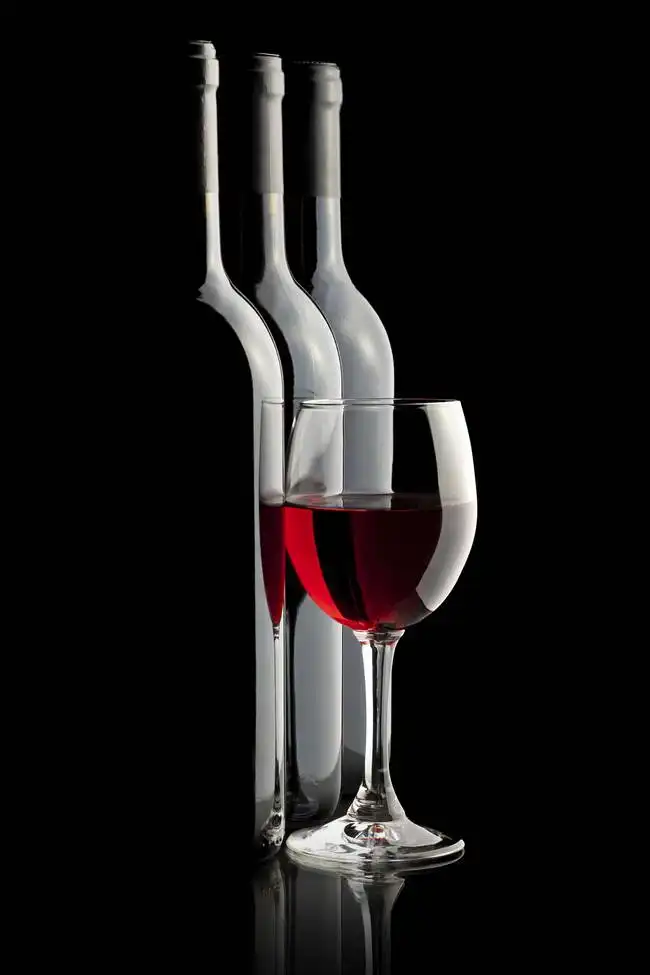 Unknown: Still life with wine on a black background