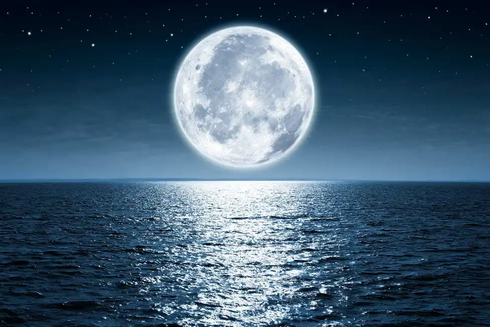 Unknown: Full moon over the ocean