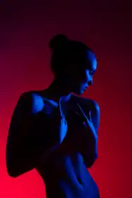 Guryanov, Andrey: Young woman in casual clothes standing under neon light