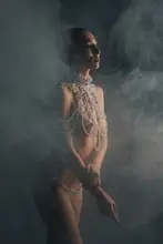 Guryanov, Andrey: A naked girl emerges from puffs of colored smoke