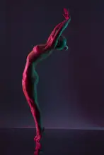 Guryanov, Andrey: Young naked woman dance against dark purple background