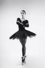 Alexandr: black swan. ballerina in a black tutu shows elements of ballet dance in motion
