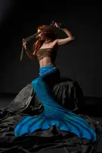 Guryanov, Andrey: Sexy redhead mermaid with blue tail and boobs wrapped in net cloth hiding eyes